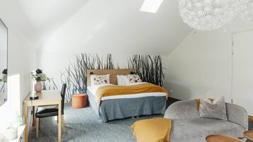 A modern bedroom with a bed, a desk, a sofa, and a unique ceiling light fixture.