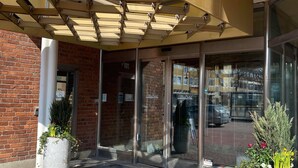 A hotel entrance with a sign reading "HOTEL" and a "No Smoking" sign. There are potted plants outside the entrance. - Hotell Alfred Nobel (Karlskoga)