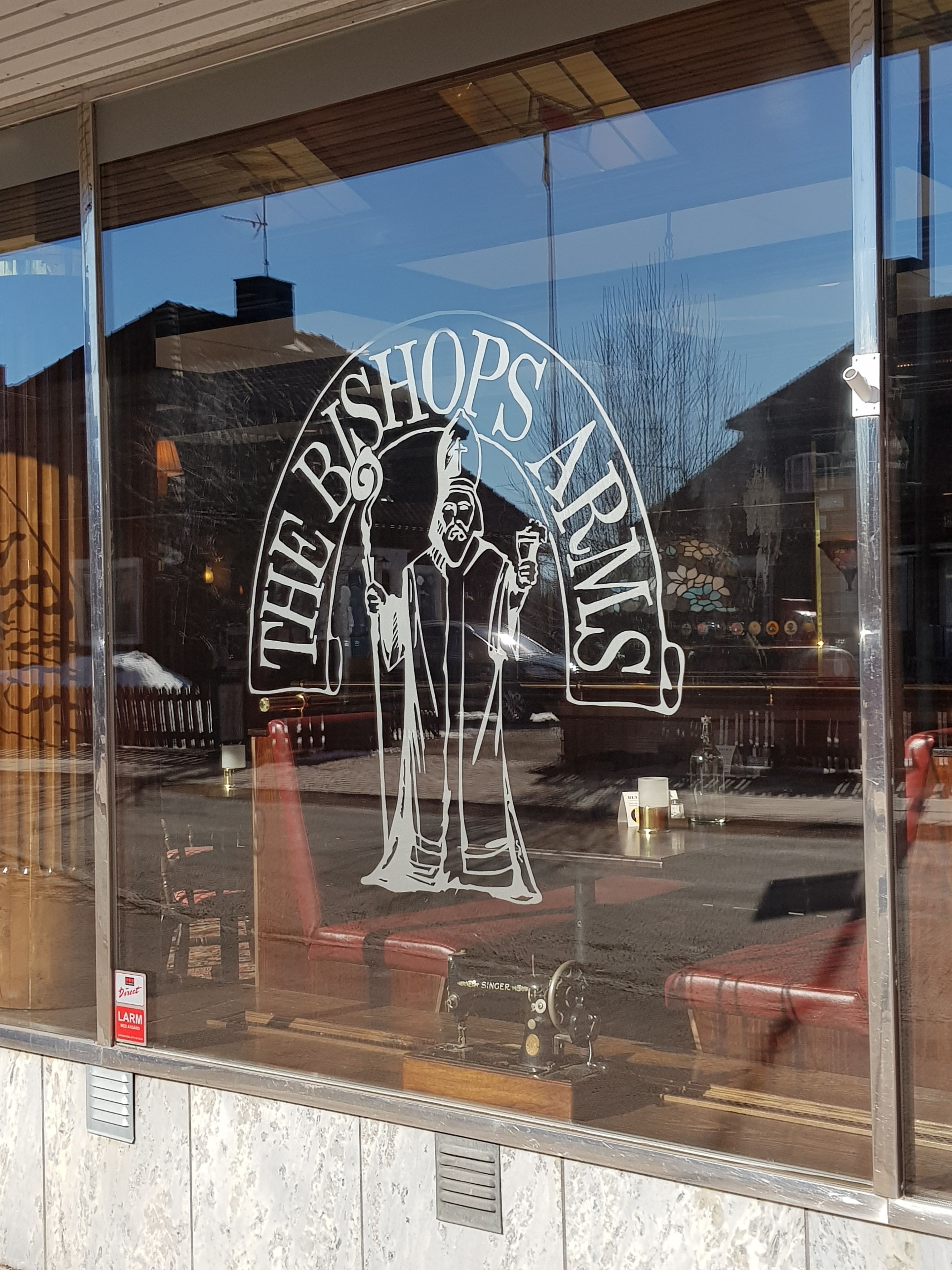 A window with a logo reading "The Bishops Arms."