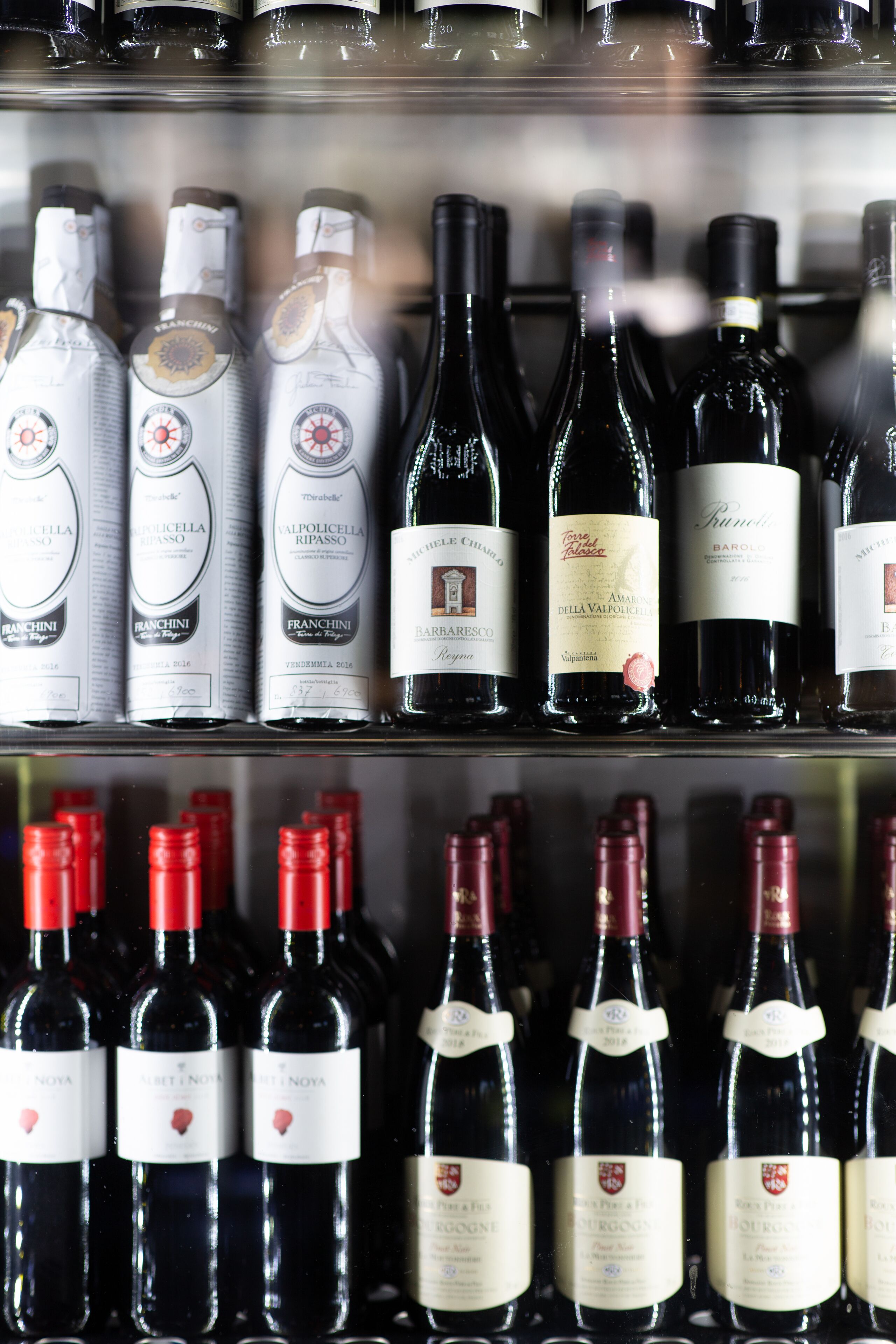 A wine rack with various bottles of wine.