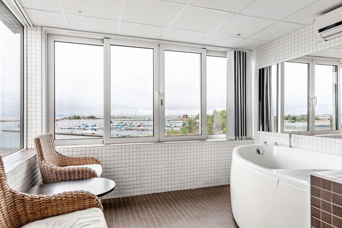 suite, 1 queen bed, jetted tub, sea view | bathroom | hair dryer, towels
