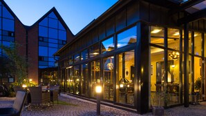 A modern building with large glass windows and a brick facade. - Home Hotel Carlscrona (Karlskrona)