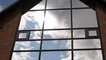 A building with a large, grid-like window structure reflecting the sky.