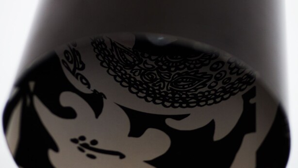 A black pendant light with a floral pattern. - Anno 1647 (Stockholm)