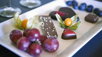 A dessert platter with various chocolates and fruits.
