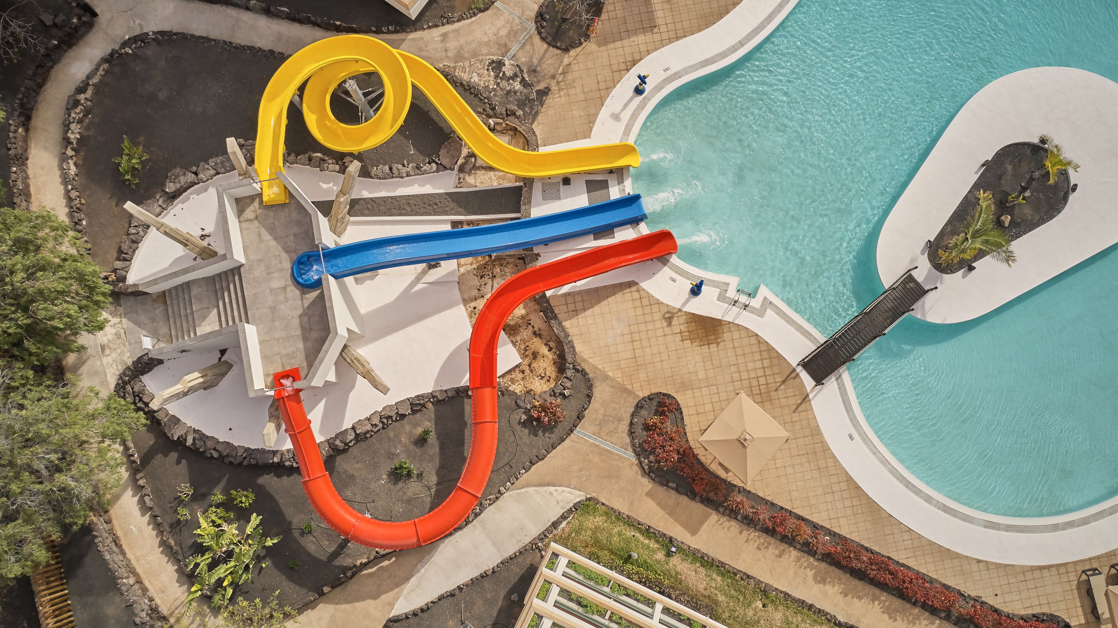 An aerial view of a water park with multiple slides and a swimming pool.