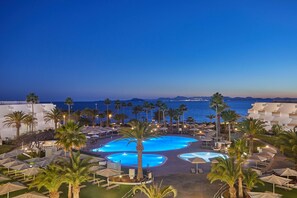 A resort with multiple swimming pools, palm trees, and beach views. - Grand Hyatt Lanzarote Playa Dorada Resort (Yaiza)