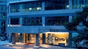 A Novotel hotel with a modern facade, large windows, and a well-lit entrance. - Novotel Shenzhen Watergate (Shenzhen)