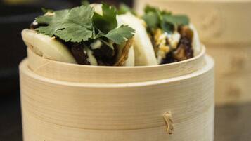 A bamboo steamer with food inside, placed on a table.