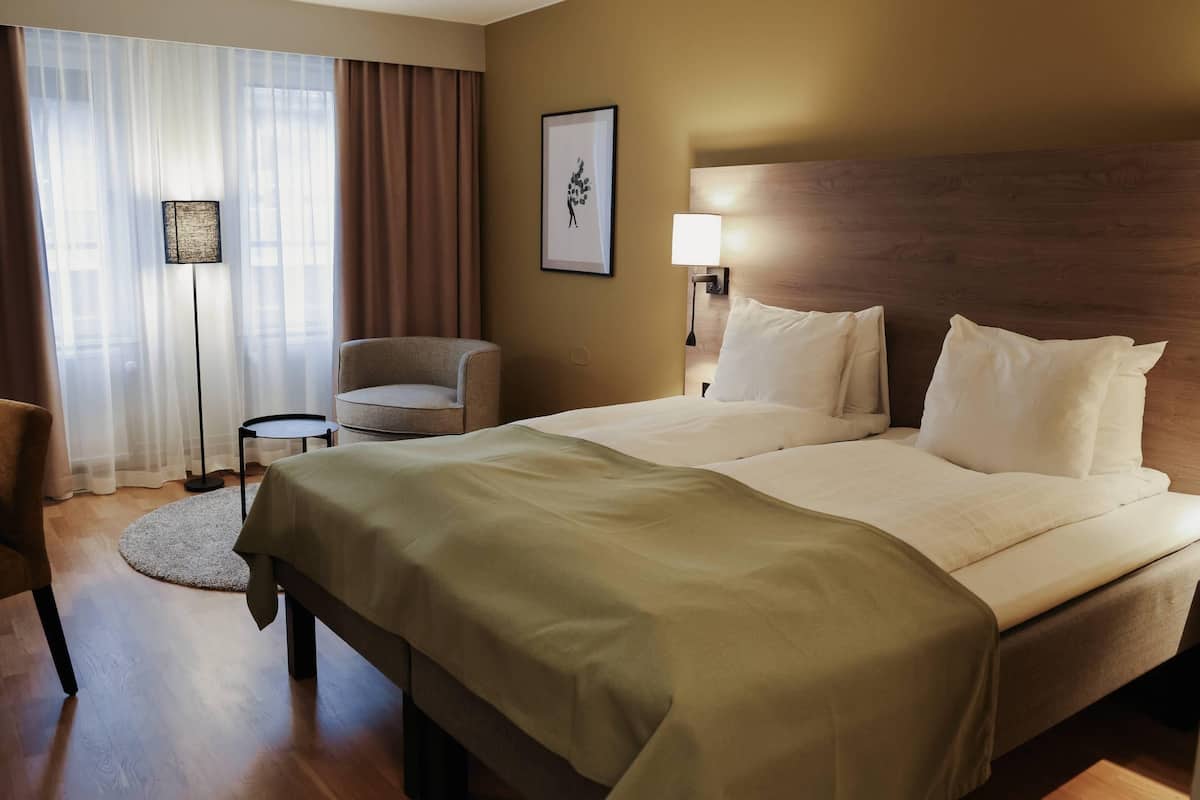 Hypo-allergenic bedding, desk, laptop workspace, blackout curtains
