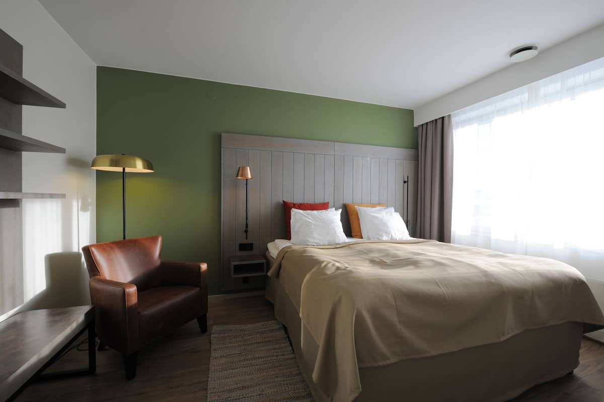 Hypo-allergenic bedding, desk, laptop workspace, blackout drapes