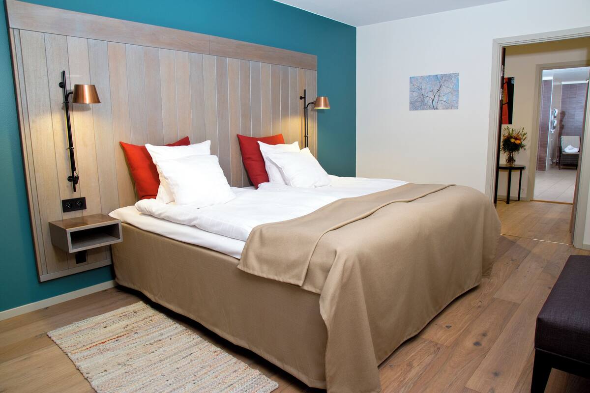 Hypo-allergenic bedding, desk, laptop workspace, blackout drapes