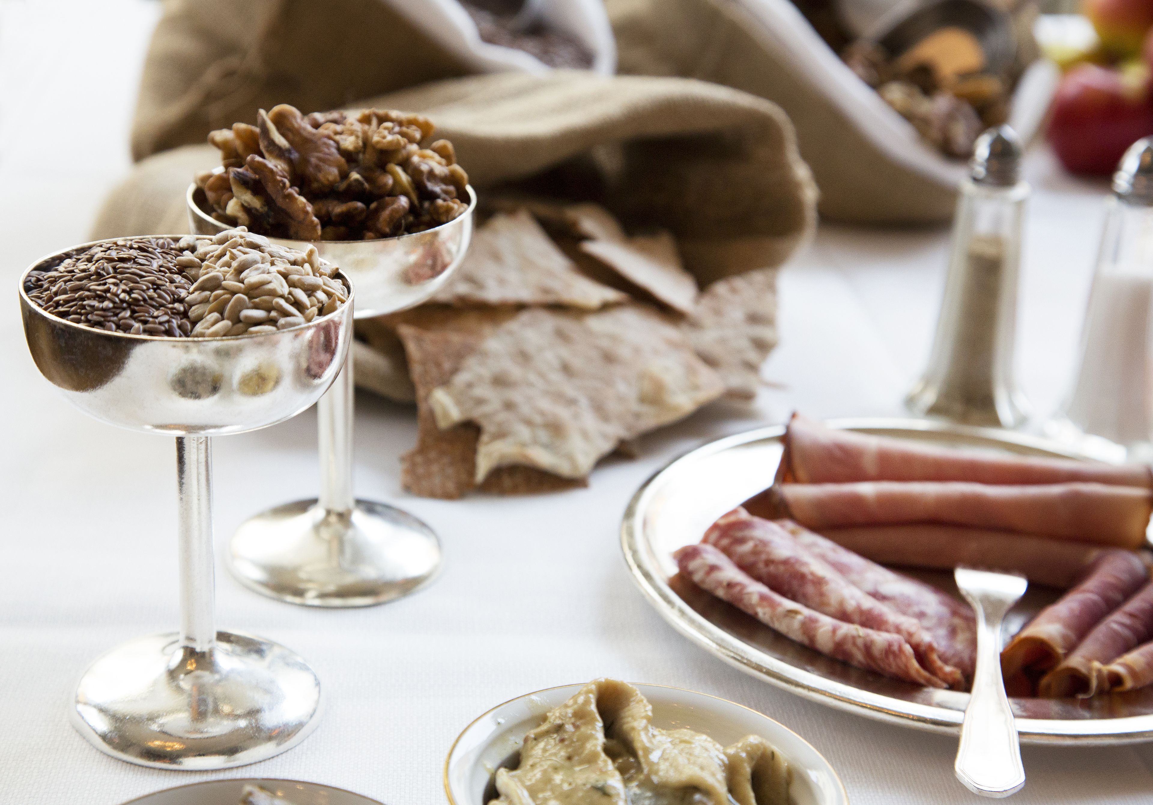 A table with various food items including nuts, bread, and meats.