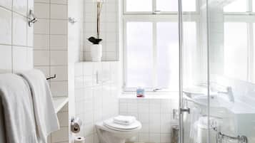 A modern bathroom with a toilet, bidet, and sink.