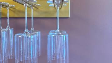 A row of empty wine glasses hanging on a wall.