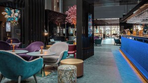 A modern interior with seating areas, a bar, and decorative elements like plants and a waterfall feature. - Radisson Blu Scandinavia Hotel (Gothenburg)