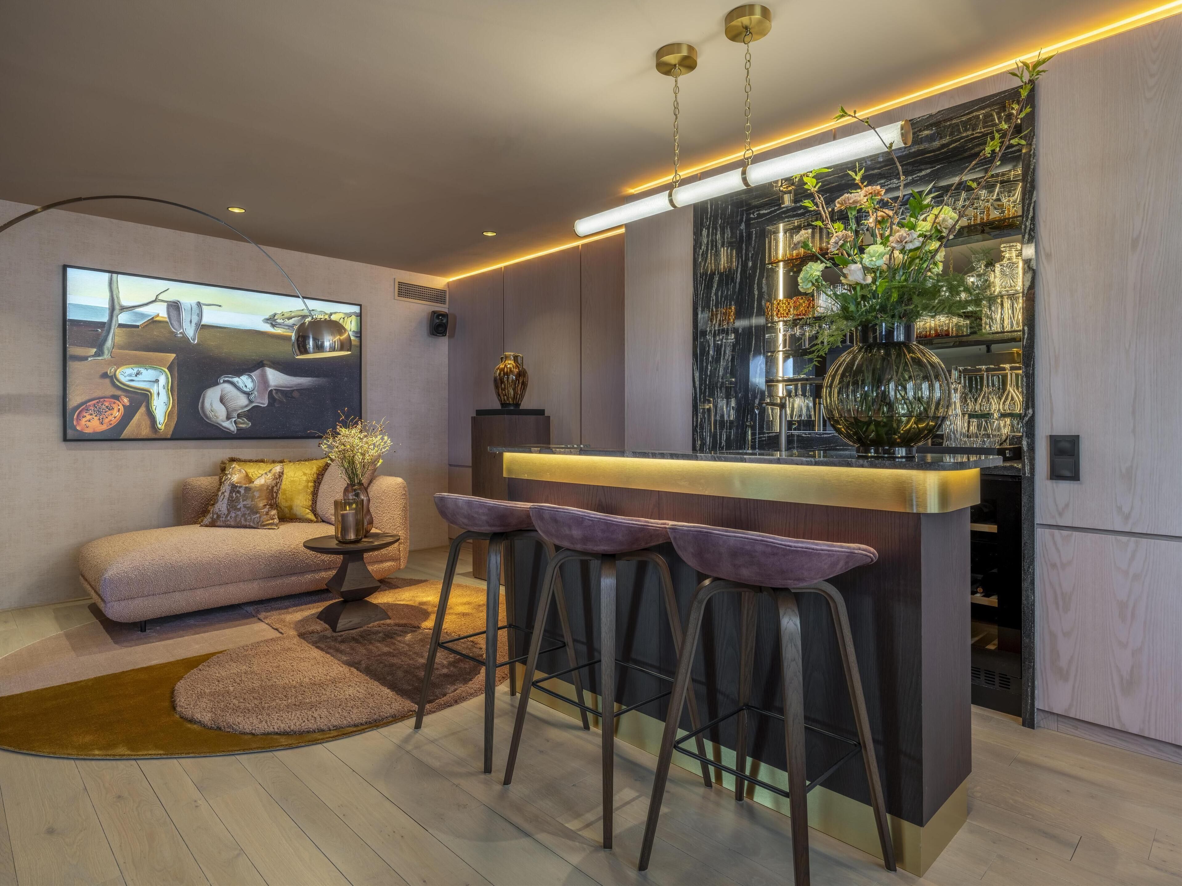 A modern kitchen with a bar area, a sofa, and a coffee table.