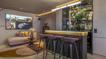 A modern kitchen with a bar area, a sofa, and a coffee table.