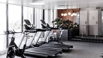 A gym with treadmills, a stationary bike, and a sauna.