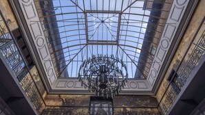 A high ceiling with a glass dome and a central chandelier. - Oatlands Park Hotel (Weybridge)