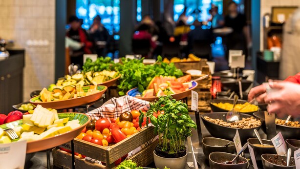 A buffet with various food items including fruits, vegetables, and salads. - Scandic Stortorget (Malmö)