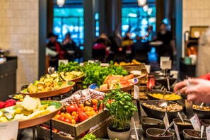 A buffet with various food items including fruits, vegetables, and salads. - Scandic Stortorget (Malmö)