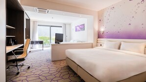 A modern hotel room with a large bed, a desk with a chair, a television, and a view of the outdoors. - B&B HOTEL Mons Centre (Mons)