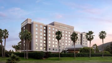 DoubleTree by Hilton features a modern, symmetrical design with a grid of rectangular windows and a prominent hotel sign.