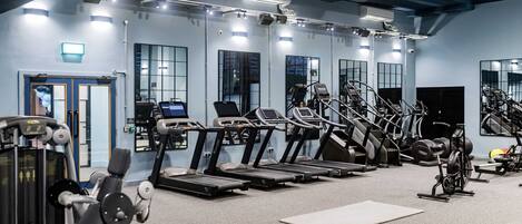A gym with treadmills, ellipticals, and weight machines.
