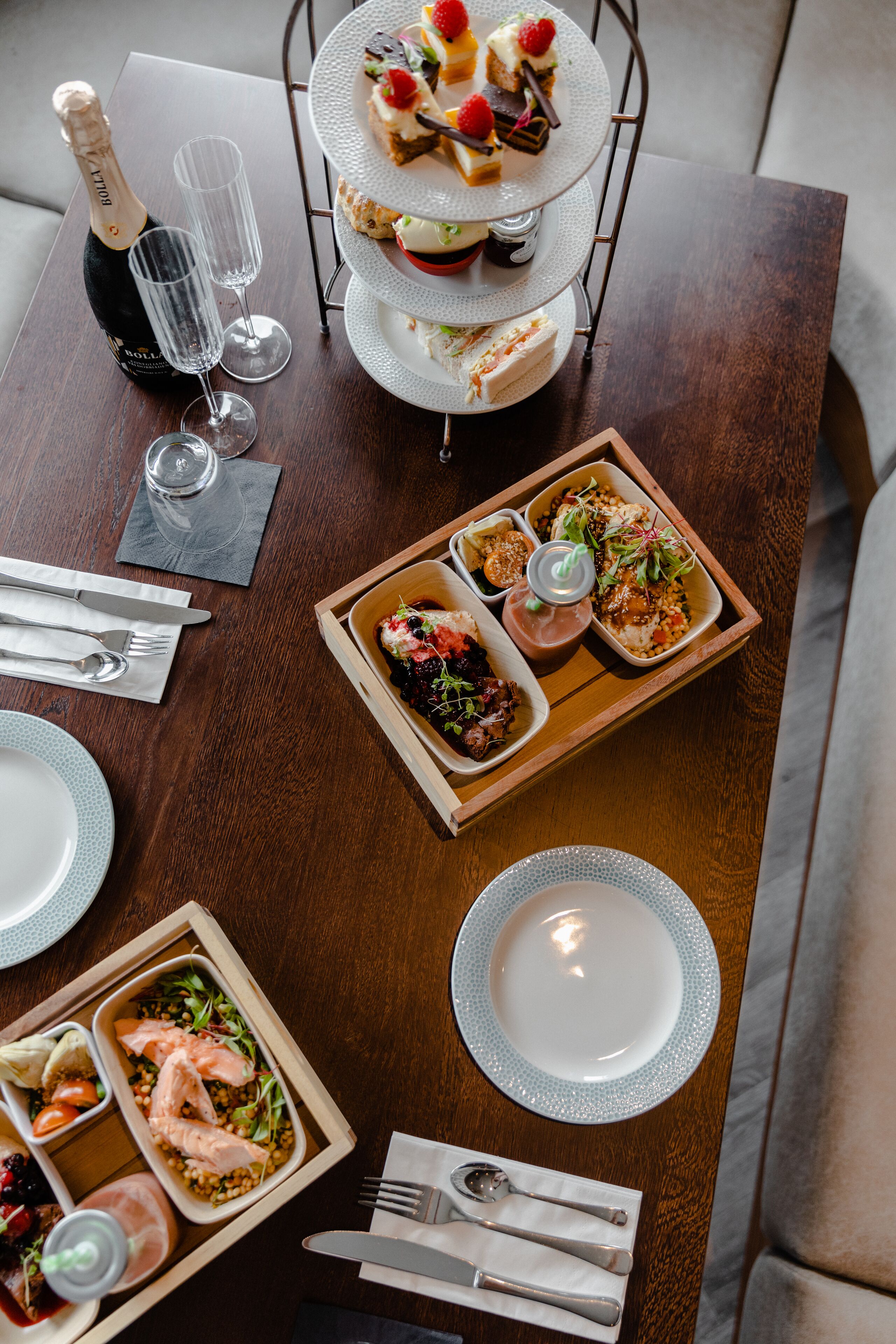 A dining table set with various dishes, glasses, and cutlery.
