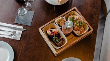 A dining table set with various dishes, glasses, and cutlery.