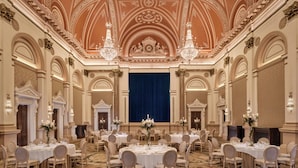 A grand ballroom with ornate ceiling, chandeliers, and round tables set for a formal event. - The College Green Hotel Dublin, Autograph Collection (Dublin)