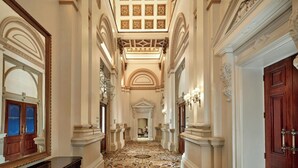 A grand hallway with ornate columns, a patterned floor, and a large mirror on the left. - The College Green Hotel Dublin, Autograph Collection (Dublin)