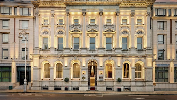 A grand building with classical architecture, featuring a central entrance with a detailed pediment, multiple arched windows, and a symmetrical facade. - The College Green Hotel Dublin, Autograph Collection (Dublin)