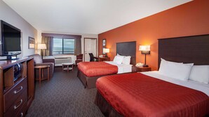 A hotel room with two beds, a TV, a desk, and a chair. - AmericInn by Wyndham Ashland (Ashland)
