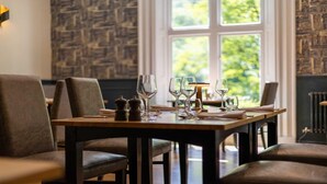 A dining area with a table set for four, including wine glasses and cutlery. - Best Western Valley Hotel (Telford)