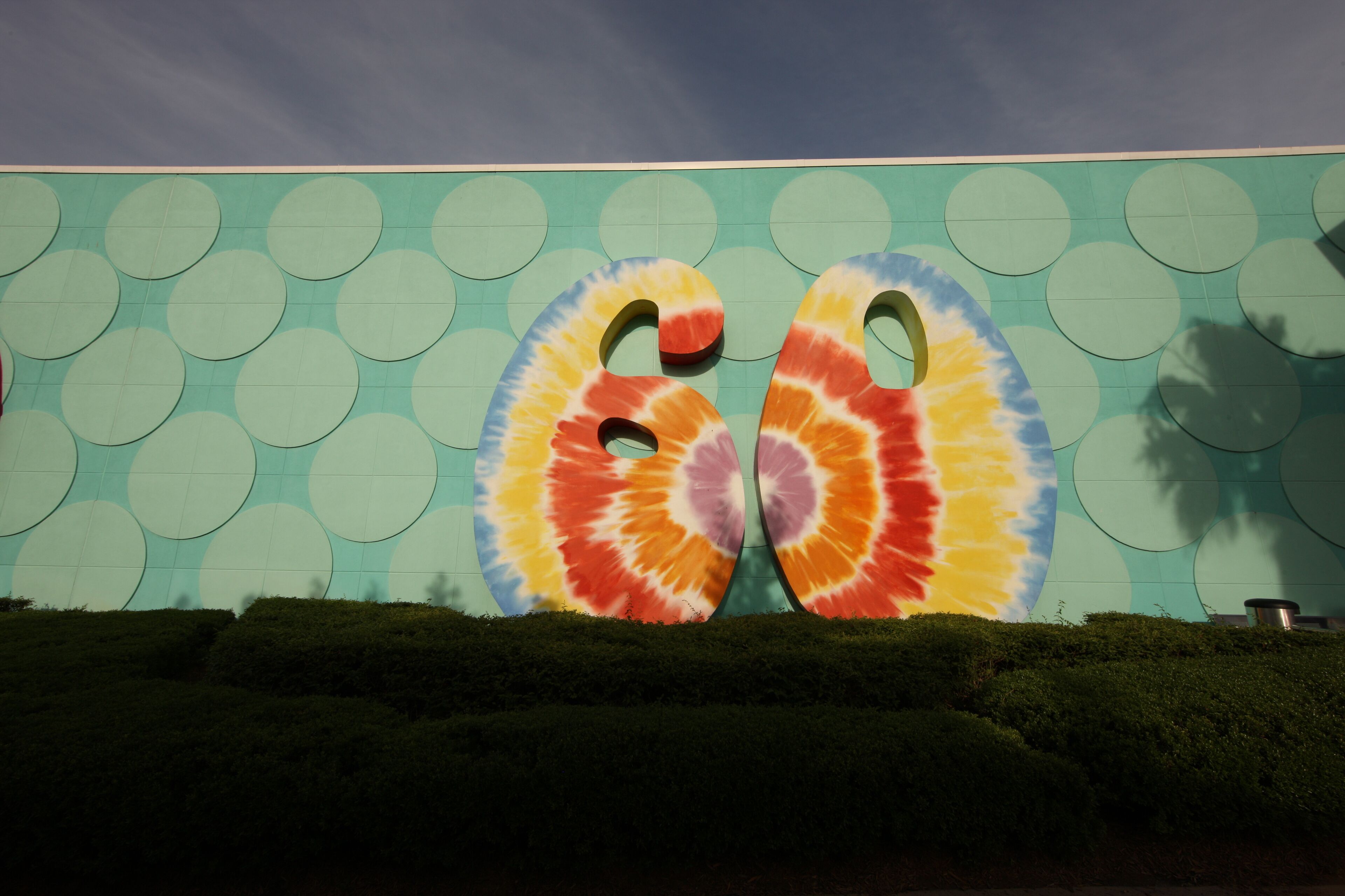 A building facade with a large, colorful, abstract art installation.