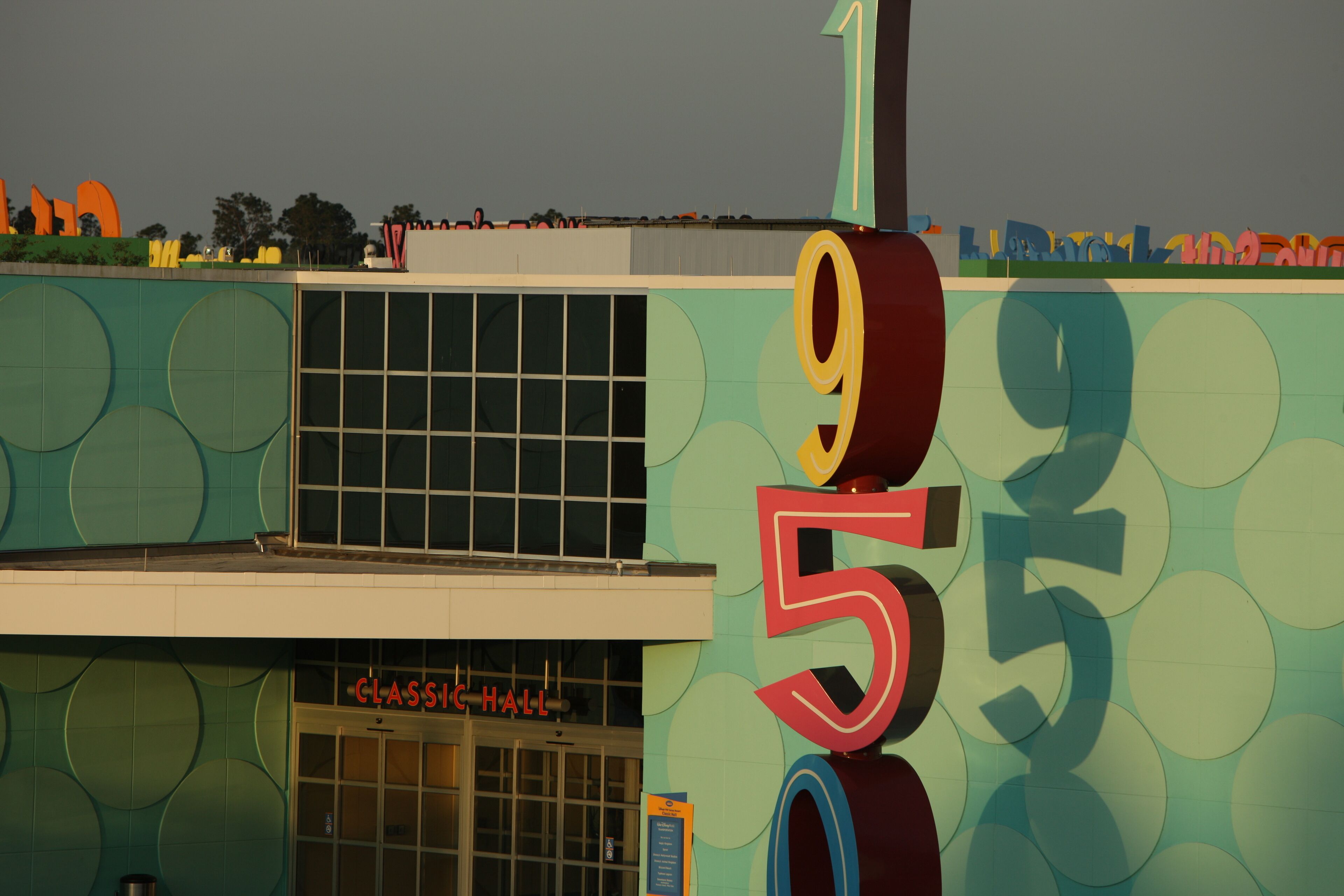 A building with a large number '950' on its facade, a sign reading 'CLASSIC HALL', and a window with a grid pattern.