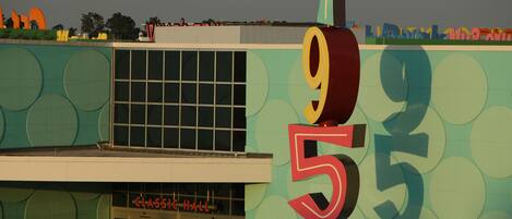 A building with a large number '950' on its facade, a sign reading 'CLASSIC HALL', and a window with a grid pattern.
