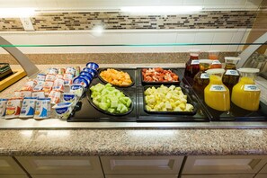 A breakfast buffet with various food items and beverages. - Hilton Garden Inn Atlanta Northpoint (Alpharetta)