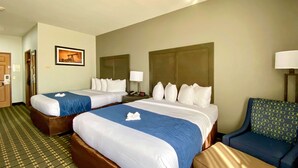 A hotel room with two beds, a desk, a chair, a lamp, and a framed picture on the wall. - Comfort Inn Owasso - Tulsa (Owasso)