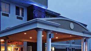 A hotel entrance with a covered porch, columns, and a brick facade. - Comfort Inn Owasso - Tulsa (Owasso)