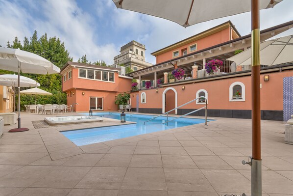 Outdoor pool, open 9:00 AM to 7:00 PM, pool umbrellas, pool loungers