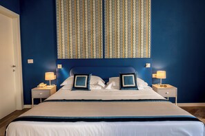 Relax in comfort with a large bed, two nightstands, and a stylish design.