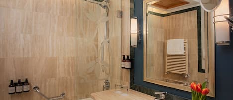 A modern bathroom with a bathtub, a sink, and a shower area.