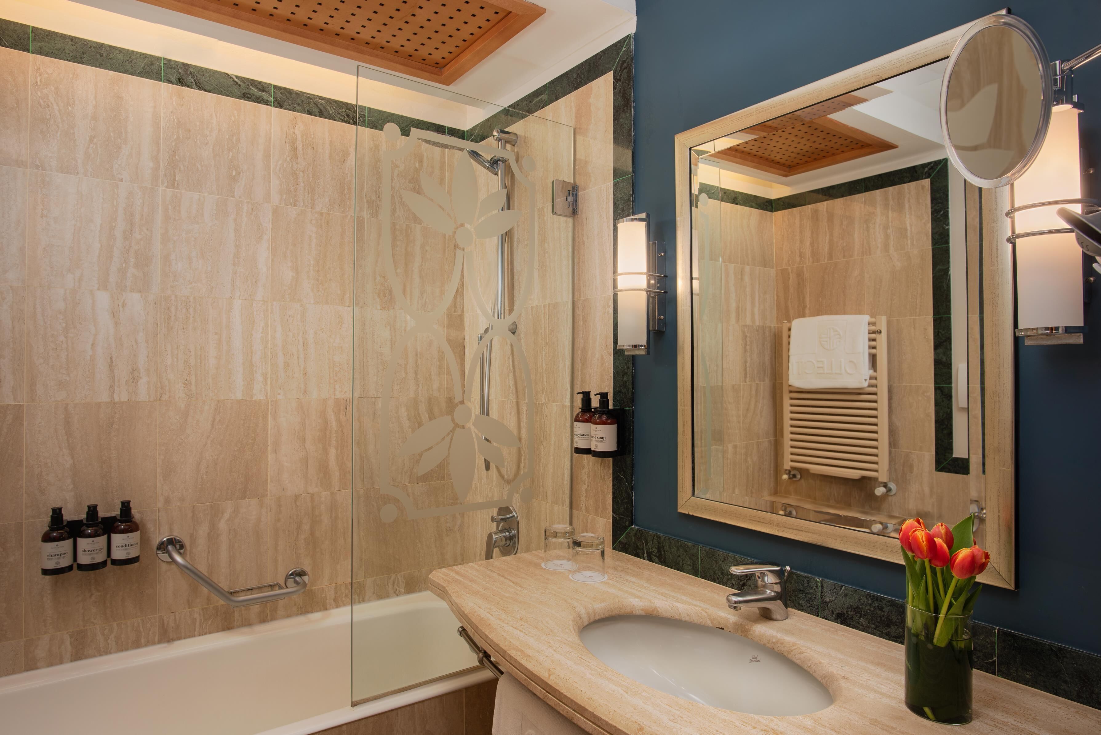 Een moderne badkamer met een bad, een wastafel en een douchehoek.