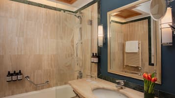 Een moderne badkamer met een bad, een wastafel en een douchehoek.
