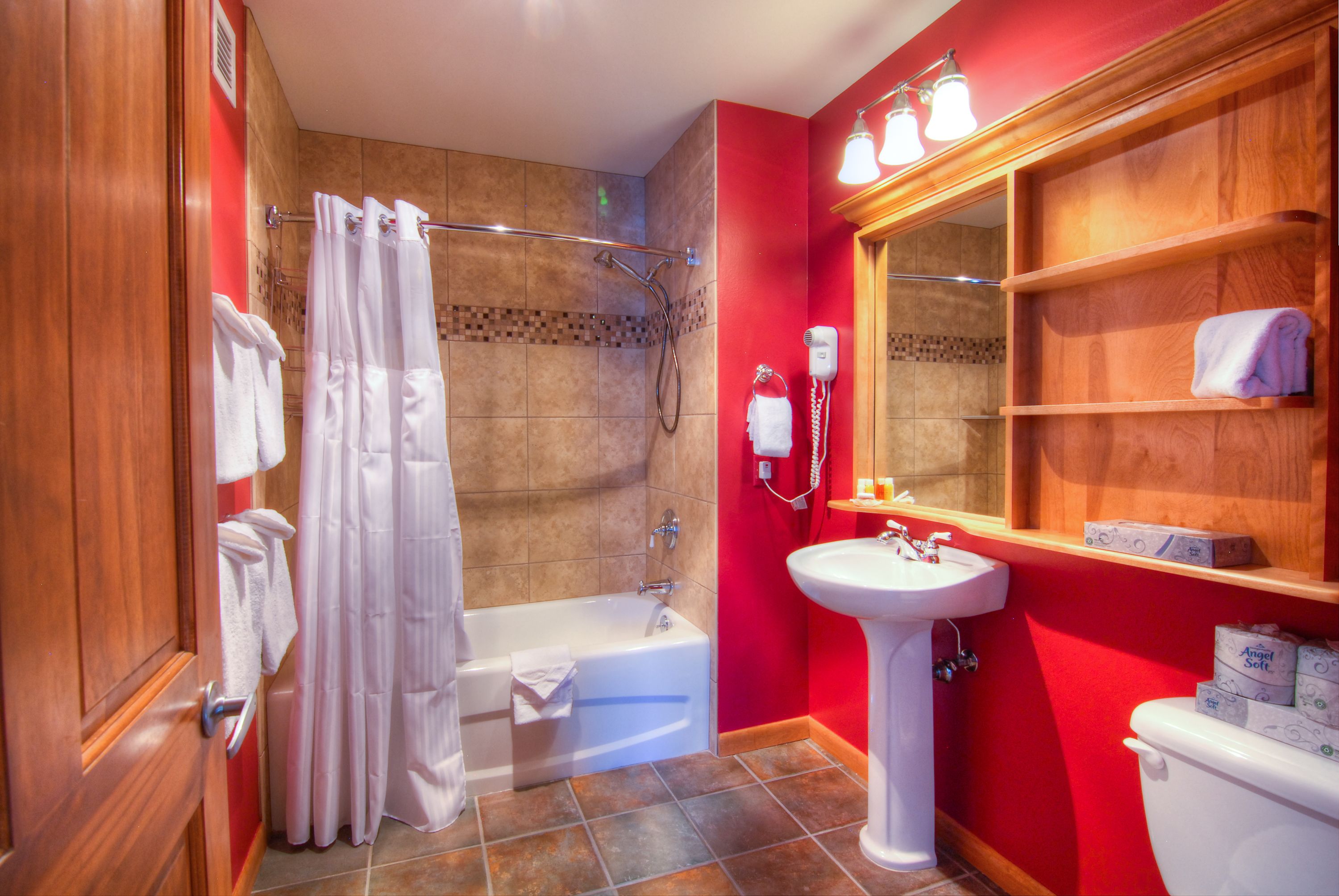 Un baño con bañera, ducha, lavabo e inodoro.