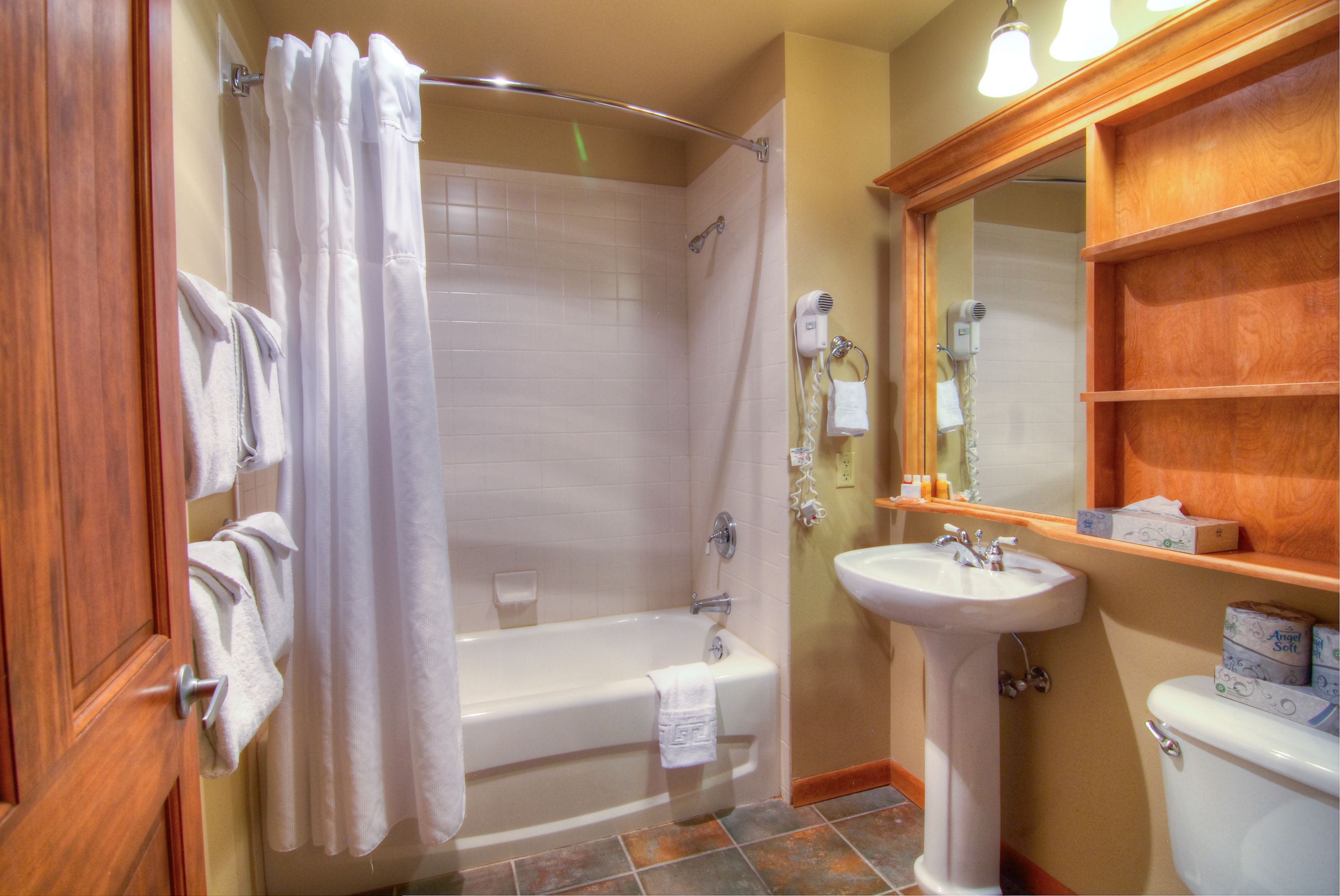 A bathroom with a bathtub, a sink, and a toilet.