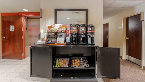 A self-service coffee station with various coffee options and snacks.